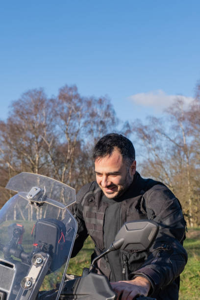istock Young man happy next to his motorbike 1925445047