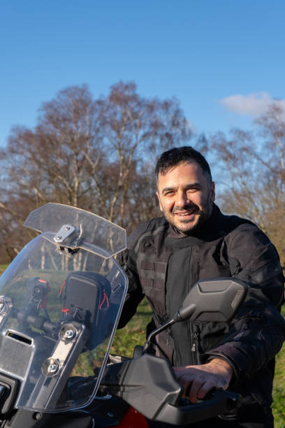 istock Young man with motorbike looking at camera 1925446063