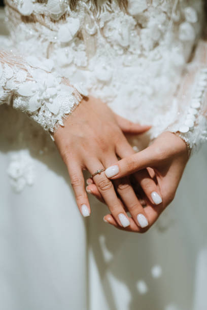 istock the bride holds her tenderly and touches the engagement ring 1925474205