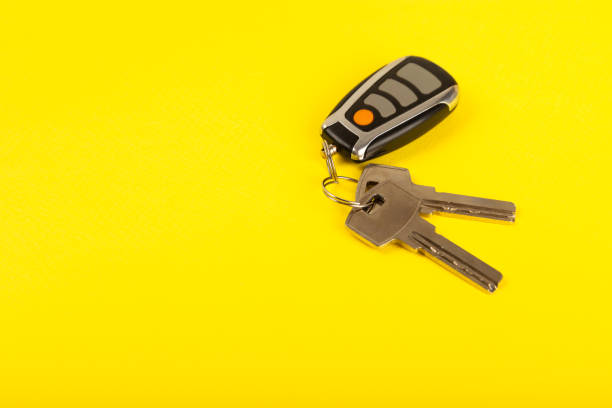 Keychain with key ring isolated on a colored background. Concepts for real estate and moving home or renting property. Buying a property. Mock-up keychain.Copy space.