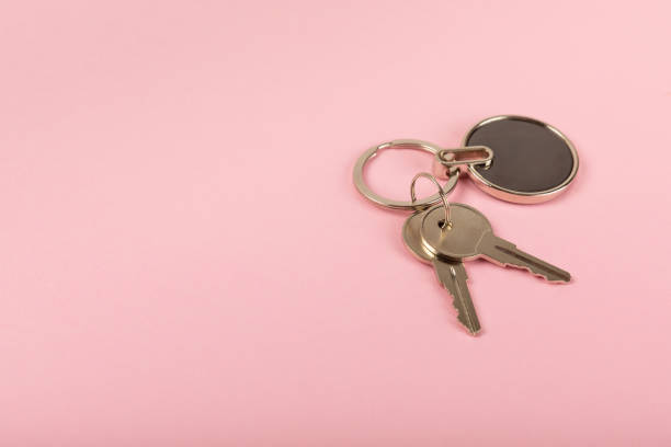 istock Keychain with key ring isolated on a colored background. Concepts for real estate and moving home or renting property. Buying a property. Mock-up keychain.Copy space. 1925481554