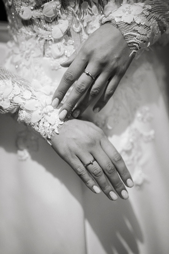 the bride holds her tenderly and touches the wedding ring