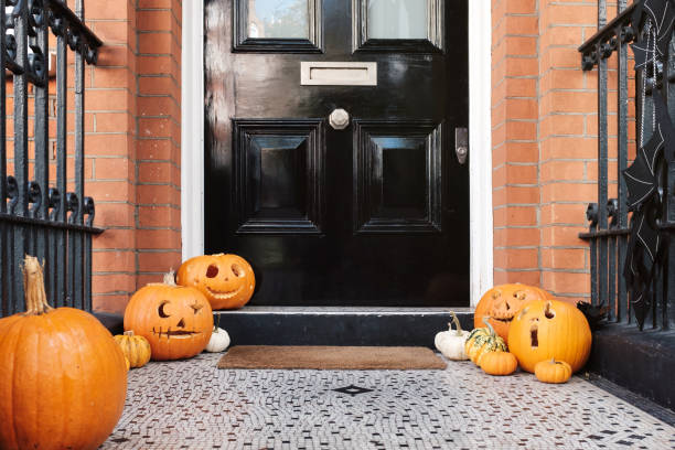 istock Halloween pumpkins on front porch, exterior home decor 1925495643