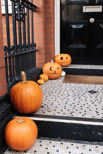 istock Halloween pumpkins on front porch, exterior home decor 1925496169