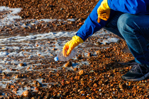 istock Mid adult man cleaning plastic pollution from the beach 1925497247
