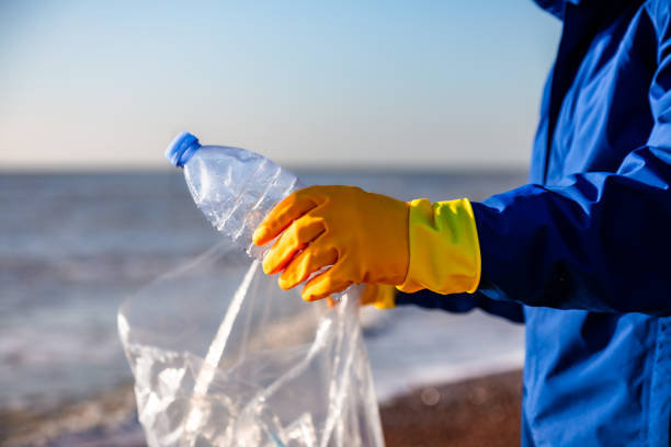 istock Mid adult man cleaning plastic pollution from the beach 1925498284