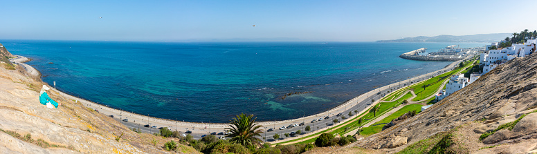 Tangier, Morocco. October 15th, 2022 - Rock in the Phoenician cemetery, facing the coast of Merkala, the Hafa Garden and the port to the right and the Spanish coast opposite in the distance. Panorama
