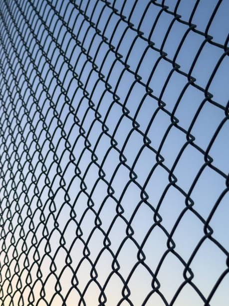 istock Dusk Sky and Chain Link Fencing 1925514608