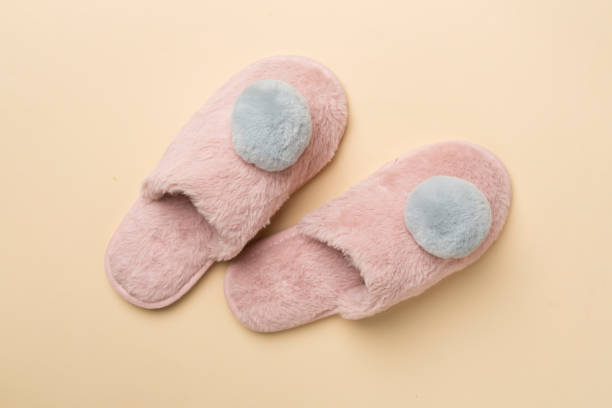 istock Soft pink slippers on color background, top view 1925515130