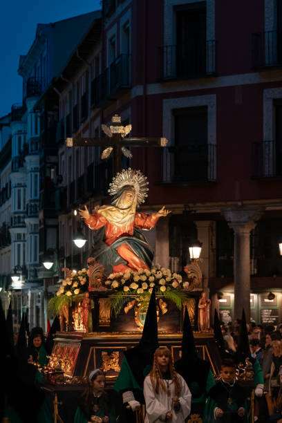 Carving of the Virgen de los Dolores in procession through the streets of Valladolid-Spain. Valladolid, Valladolid-Spain, April 03, 2023; during the celebration of the Christian Easter commemorating the Passion of Jesus, the streets of Valladolid, Castilla y León-Spain will be processionally decorated with polychrome wood carvings. Carving of the Virgen de los Dolores processional by the penitents of her brotherhood. the passion of jesus stock pictures, royalty-free photos & images