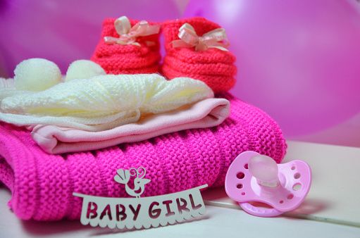 Baby girl knitted sandal, booties, shoes baby newborn, blank postcard. cocept it s a girl or baby shower