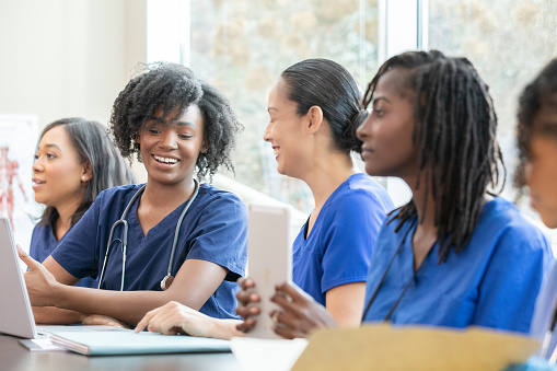 Diverse women attend medical education class at nursing school
