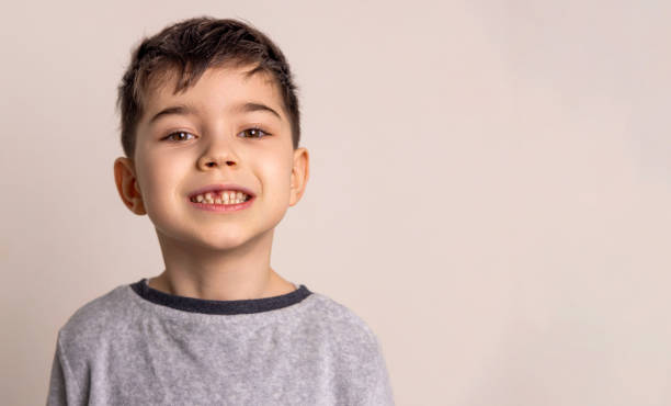 istock kid with missing milk teeth, close up portrait photography 1925605292