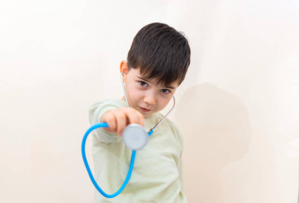 Little kids pretending to be a doctor. Shot of a cute little girl with a stethoscope examining her brother. Children playing doctors.