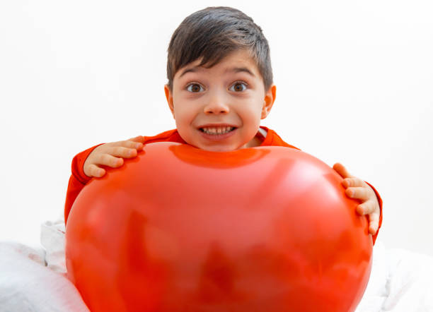 Dad and toddler preparing birthday party, decorating the house and inflating balloons. Surprise party.