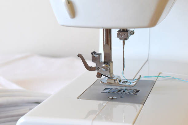 istock Sewing machine with blue thread, detail of tailoring machine 1925612703
