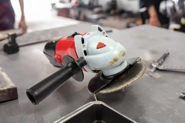 Hand-held Electric Angle-Grinder in a metal workshop