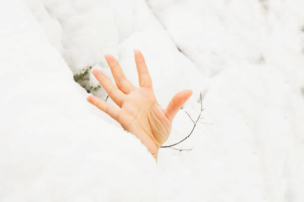 an arm sticking out from under the snow, an avalanche, a snowfall, a disaster