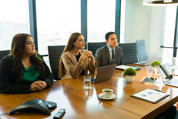 istock Business partners paying attention to a presentation in a meeting room 1925656185