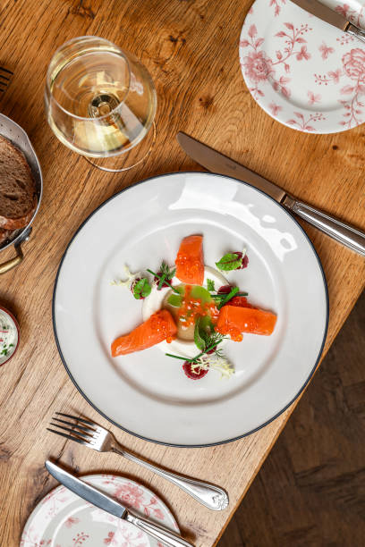 istock Elegant Salmon Appetizer dish with smoked salmon, salmon caviar, vinaigrette and radish cream served  in Michelin Star Restaurant 1925656708