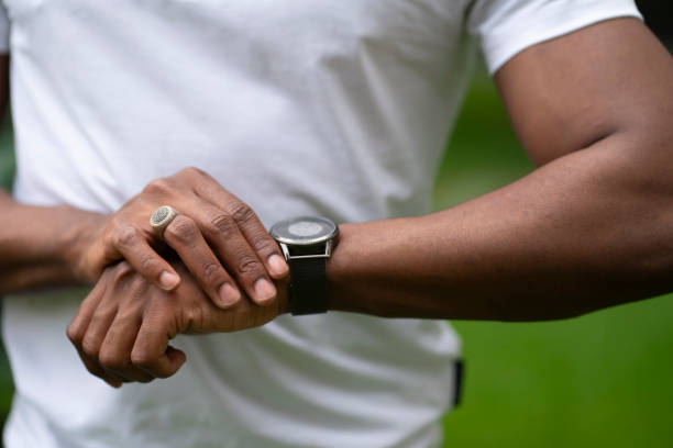 istock checking time, african american looking at his wrist watch 1925709396