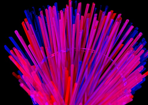 Colorful abstract representing vibrant data filled fiber optic cable in space. Red, blue and purple strands of data flow in a high technology society.