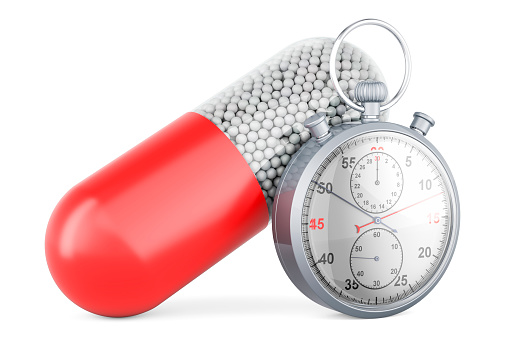 Medicament capsule with stopwatch, 3D rendering isolated on white background