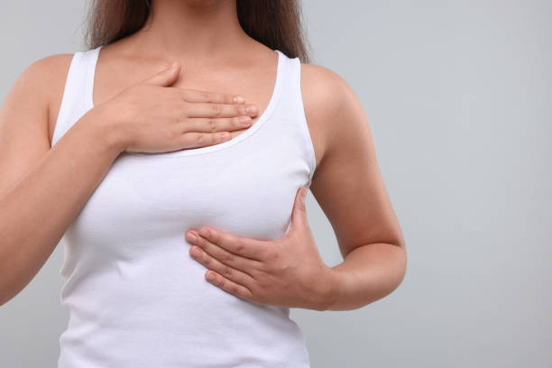 istock Woman doing breast self-examination on light grey background, closeup 1925720067