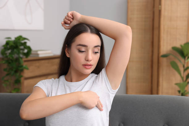 istock Beautiful young woman doing breast self-examination at home, space for text 1925745712
