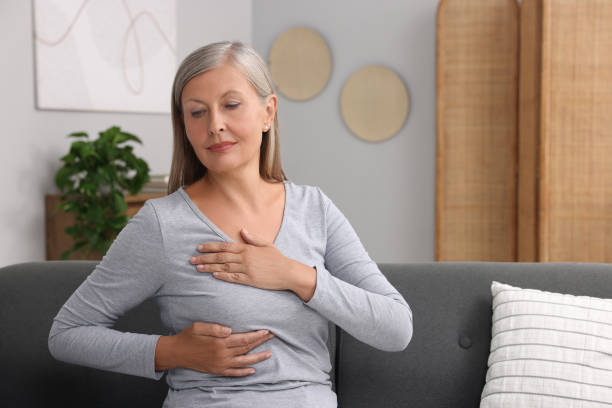 istock Beautiful senior woman doing breast self-examination at home, space for text 1925749432
