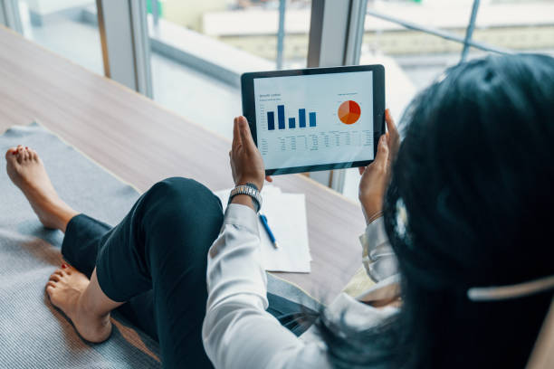 istock Young businesswoman looking at financial data on a digital tablet 1925765599