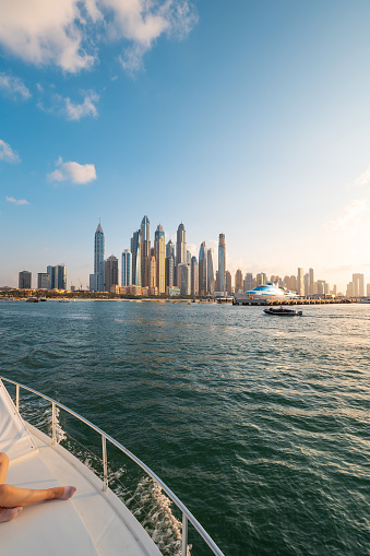 Dubai Marina harbor cruise on a calm sunny day, with a beautiful view of the iconic and luxurious cityscape of the United Arab Emirates