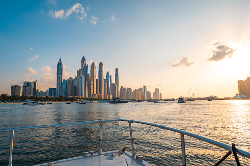 Dubai Marina harbor cruise on a calm sunny day, with a beautiful view of the iconic and luxurious cityscape of the United Arab Emirates