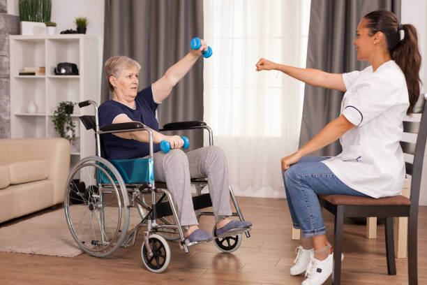 istock Invalid old woman training her arms 1925827406