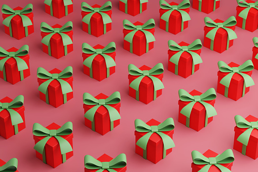 Array of red gift boxes with green ribbons on pink background. Illustration of the concept of seasonal presents