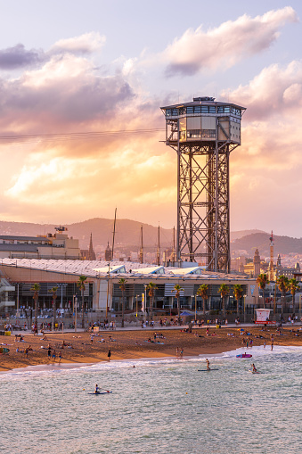 Barcelona, Spain - 3 Aug 2023: View over the famous Barceloneta beach during sunset in Barcelona, Spain.