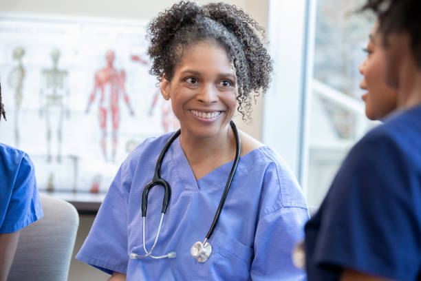 istock Mature nurse meets with healthcare workers during training class event 1925871059