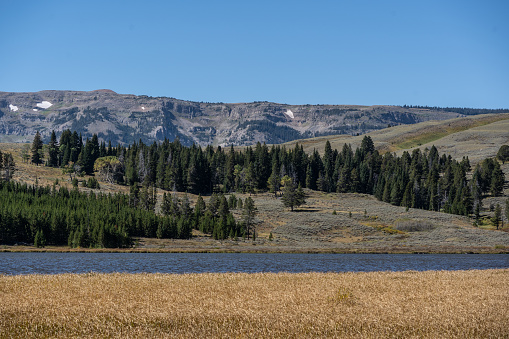 Beautiful Swan Lake in autumn with the Gallatin Mountain Range against a blue sky background