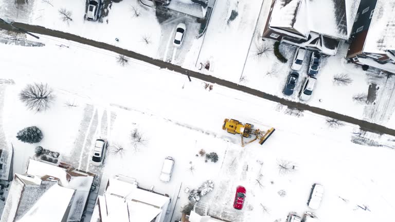 Snowplow Clears Suburban Street