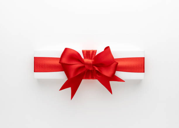 White gift box with red ribbon isolated on white backgroundFor Valentine's Day
