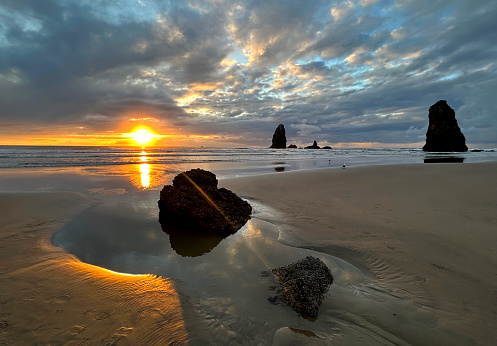 A beautiful sunset on famous Canon Beach on the Oregon Coast.  This beach is famous for its rock formations and sea stacks.