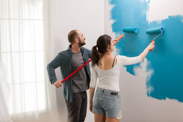 istock Husband helps his wife to paint 1925960206