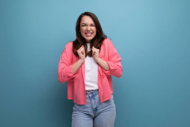istock optimist young lady in shirt and jeans on studio isolated background 1925983595