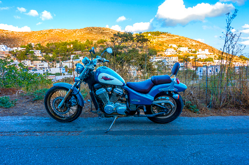 Leros Island, Greece – November 5, 2023: Harley-Davidson on the road and sunny background.