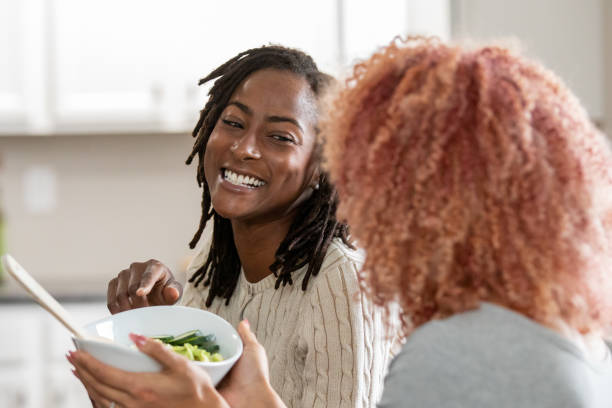 istock Women delight in a wholesome meal during a shared dinner celebration 1925999997