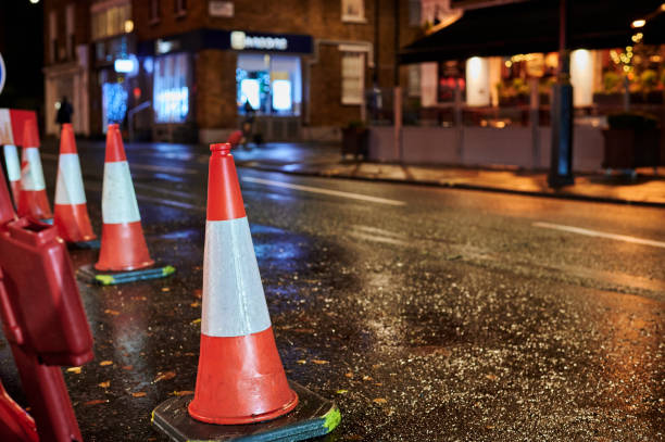 istock Low view of roadwork cones on wet street at night with blurred background 1926007766