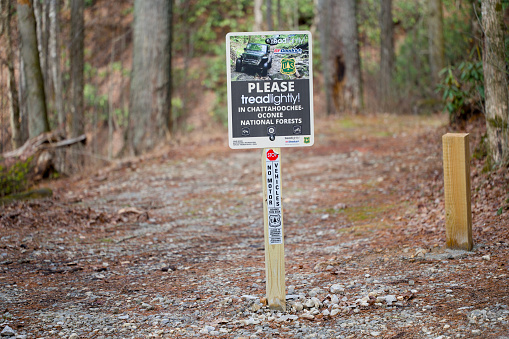 Helen, Georgia - December 28, 2023: Please tread lightly in Chattahoochee-Oconee National Forests sign on Tray Mountain Road near Helen, Georgia.