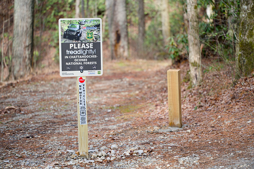 Helen, Georgia - December 28, 2023: Please tread lightly in Chattahoochee-Oconee National Forests sign on Tray Mountain Road near Helen, Georgia.