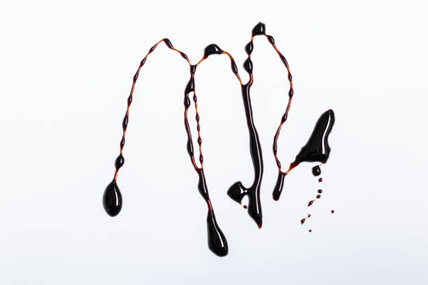 istock Black soy sauce splash on white background 1926011754