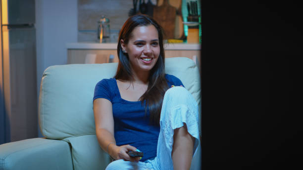 istock Amused lady watching Tv show 1926013605